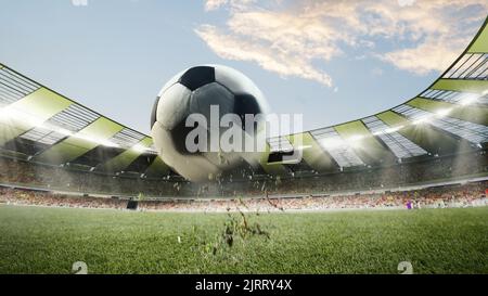 Flying soccer football ball over crowded stadium and cloudy sky at summer day. Concept of sport, championship. Blur effect Stock Photo
