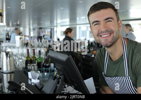Restaurant cashier in front of computer Stock Photo