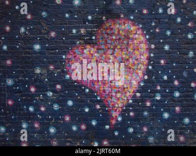 Pink Heart on Painted Brick Wall Stock Photo