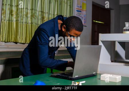 guy working on his laptop in the lab Stock Photo
