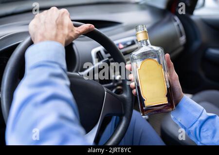 Drunk Car Accident. Man Hand With Alcohol Stock Photo