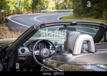 Rezzoaglio, Italy - September 30 2021. (Mazda MX-5 NC , NC2, NCFL, Miata) cockpit view with winding road in blurred background. HD wallpaper, 4k Stock Photo