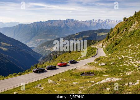 San Marco Pass, Italy - June 17, 2022. Four roadsters on beautiful alpine road. Stock Photo