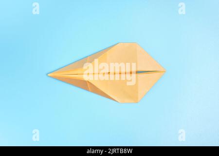 Origami Bunny. Step-by-step photo instruction on a blue background. Easter bunny. DIY concept. Step9. Rabbit 2023. Stock Photo