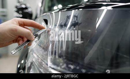 Male hand with spray, car window tint installation process, installing  procedure, tinting film Stock Photo - Alamy