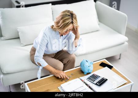 Sad Woman With Finance Problem With Calculator Stock Photo