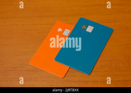 green and orange credit or debit contactless cards with contact less sign. Digital payment system. Stock Photo