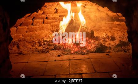 Wood fired oven. Flares of fire rising in the oven. Traditional style wood fired oven. Stock Photo