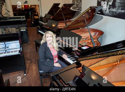 Hamburg, Germany. 25th Aug, 2022. Yvonne Trübger, owner, at a photo session to mark the 150th anniversary of Pianohaus Trübger. The piano house is one of the last piano houses that does not represent only one brand. (to dpa 'Pianohaus Trübger gives away 15 pianos for 150th anniversary') Credit: Georg Wendt/dpa/Alamy Live News Stock Photo