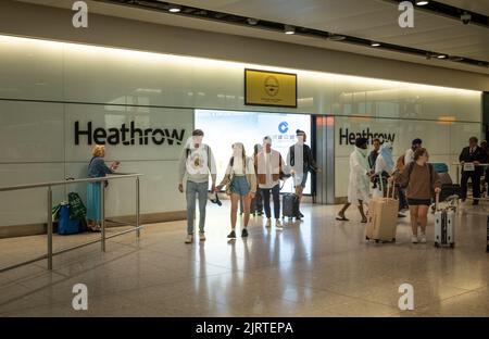 International passengers arrive at London Heathrow Airport, Terminal Two. Stock Photo