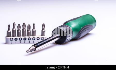 Interchangeable screwdriver set with different types of metal steel heads and bits, selective focus Stock Photo