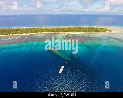 Aerial view, diving ship anchoring at the wreck of Prinz Eugen, German heavy cruiser, sunken at 22nd December 1946, Kwajalein Atoll, Marshall Islands Stock Photo