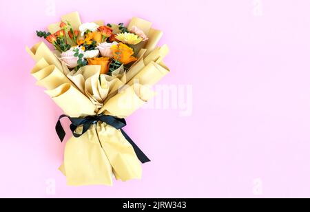 Mixed flower bouquet - Roses, gerbera daisy and carnation on pink background Stock Photo