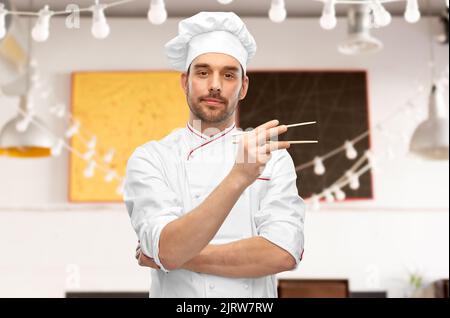 serious male chef with chopsticks Stock Photo