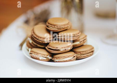 A mountain of macaroons in a plate on a wedding table. Stock Photo