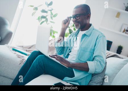Profile side photo of positive intelligent businessman working remotely on interesting project wearing eyeglasses Stock Photo