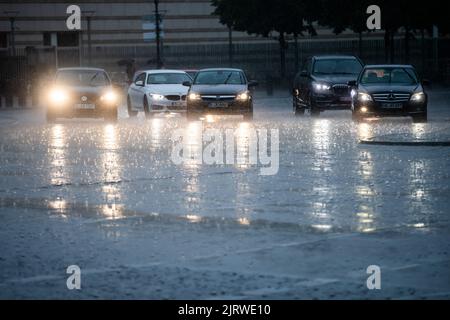 Berlin, Germany. 26th Aug, 2022. Heavy rain falls on a street near the Brandenburg Gate. Credit: Christoph Soeder/dpa/Ģ����ý Live News Stock Photo