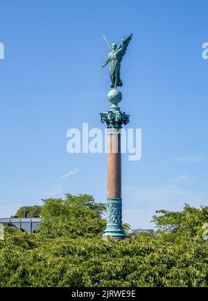 Bronze statue of Winged Victory by Ferdinand Edvard Ring crowning the Ivar Huitfeldt Column at Langelinie in Copenhagen Denmark Stock Photo