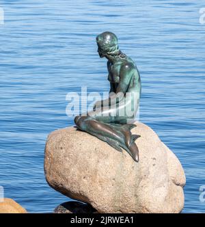 Bronze sculpture of the Little Mermaid by Edvard Eriksen on the Langelinie promenade by the harbour in Copenhagen Denmark