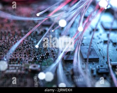 Fibre optics carrying data passing through computer circuit boards. Stock Photo