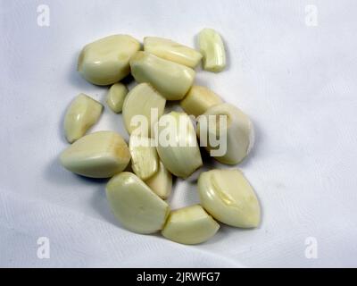 Peeled garlic cloves in set is isolated on white background with ...
