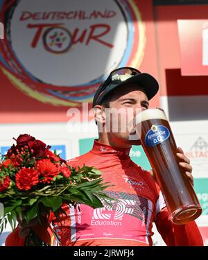 Marburg, Germany. 26th Aug, 2022. Cycling: Tour of Germany, Meiningen - Marburg (200.70 km), stage 2. Alberto Bettiol from Italy of Team EF Education-Easypost is the new wearer of the red jersey as the overall leader after his third place in the 2nd stage. Credit: Arne Dedert/dpa/Alamy Live News Stock Photo