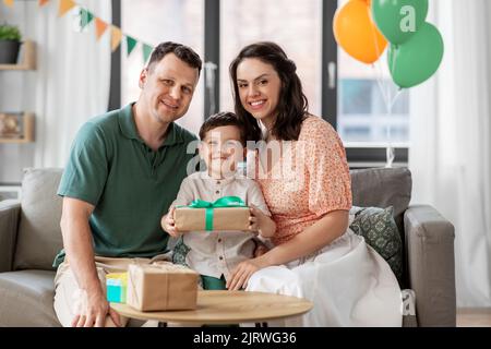 parents giving birthday present to little son Stock Photo