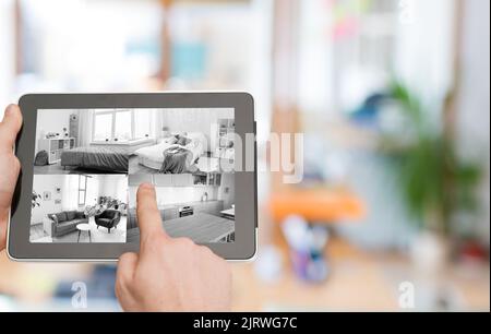 hands with video control on tablet pc at home Stock Photo
