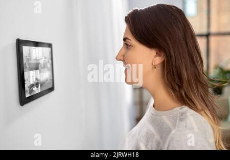 woman having video control from tablet pc at home Stock Photo