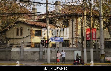An old beautiful residential house surrounded by a stone fence in the city of Shanghai, China Stock Photo
