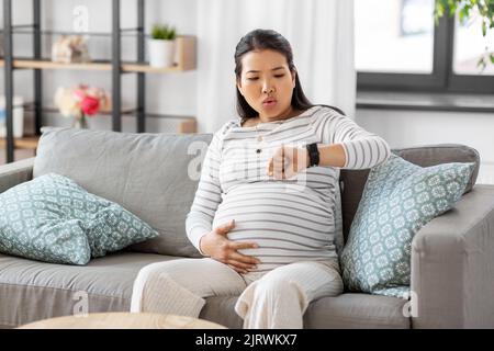 pregnant woman having labor contractions at home Stock Photo