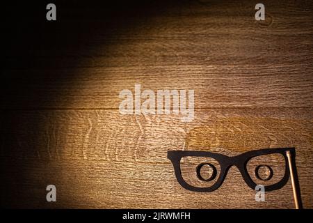 Three wedding rings in cardboard glasses on the table. Stock Photo