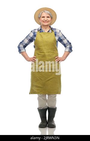 smiling senior woman in garden apron and straw hat Stock Photo