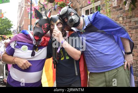 Manchester, UK. 26th August, 2022. Three men wear dog masks. LGBTQ+ Pride, Manchester, UK, begins and continues over the Bank Holiday weekend 26th to 29th August in Manchester's gay village. Organisers say: 'Manchester Pride is one of the UK's leading LGBTQ+ charities. Our vision is a world where LGBTQ+ people are free to live and love without prejudice. We’re part of a global Pride movement celebrating LGBTQ+ equality and challenging discrimination.' Credit: Terry Waller/Alamy Live News Stock Photo