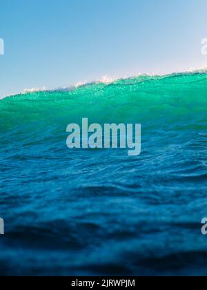 A glassy green blue wave breaking with spray Stock Photo - Alamy