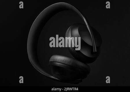 Black premium quality headphones on black background Stock Photo