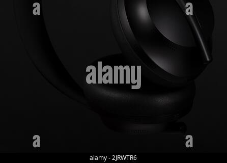Close-up of black headphones on black background Stock Photo