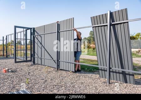 Installation of metal gates. Stock Photo