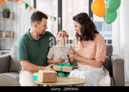 parents giving birthday present to little son Stock Photo