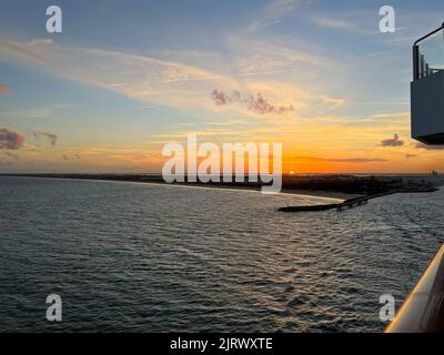 An aerial view of  Port Canaveral at sunset during a cruise ship sail away in Florida. Stock Photo