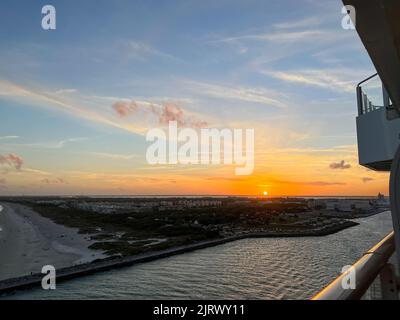 An aerial view of  Port Canaveral at sunset during a cruise ship sail away in Florida. Stock Photo