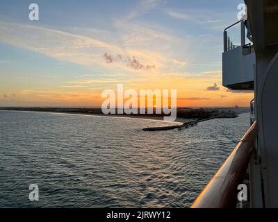 An aerial view of  Port Canaveral at sunset during a cruise ship sail away in Florida. Stock Photo