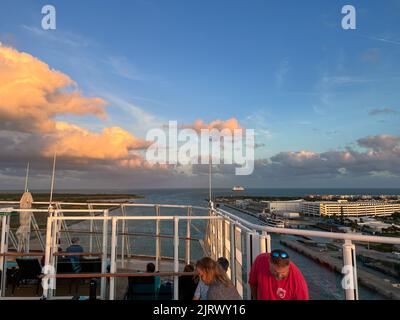 Orlando, FL USA - January 8, 2022: An aerial view of  Port Canaveral at sunset during a cruise ship sail away in Florida. Stock Photo