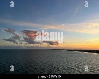 An aerial view of  Port Canaveral at sunset during a cruise ship sail away in Florida. Stock Photo