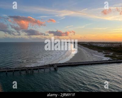 An aerial view of  Port Canaveral at sunset during a cruise ship sail away in Florida. Stock Photo