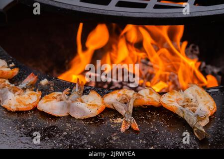 Process of grilling red prawns on brazier with hot flame - close up Stock Photo
