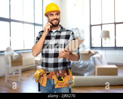 builder calling on smartphone at home Stock Photo