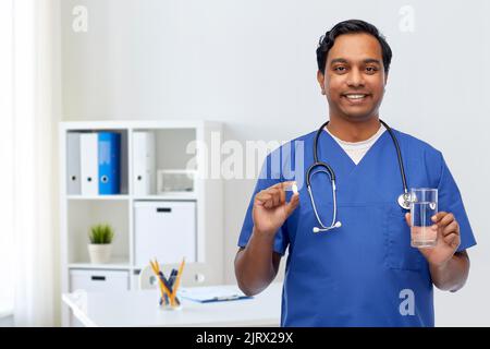 indian doctor with medicine and glass of water Stock Photo