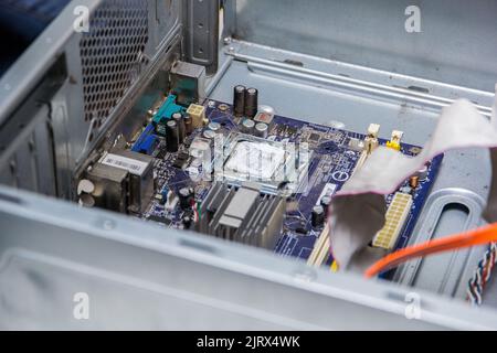 motherboard of a computer with processor on a repair table in Brazil. Stock Photo