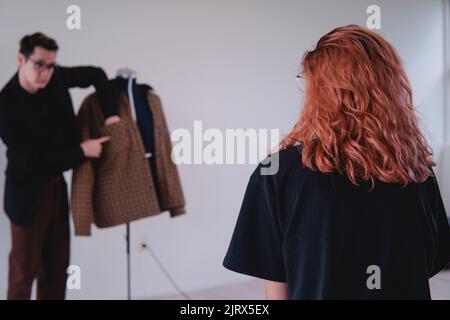 Clothing designer working with a client in the middle of the studio. Man focused on policies and. destinations thank you very much. High quality photo Stock Photo
